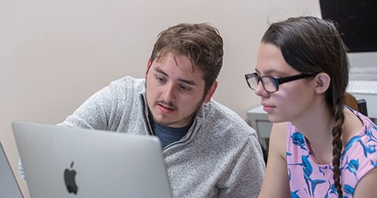 Students editing in the communication computer lab.