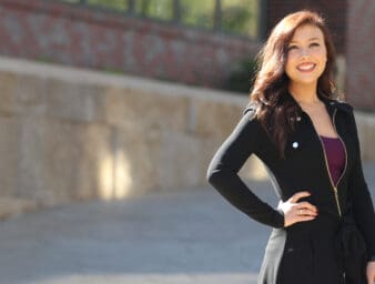 optometry scholar student maddie smith standing outside of the health professions education building