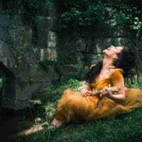 A Midsummer Night's Dream character playing next to a bridge