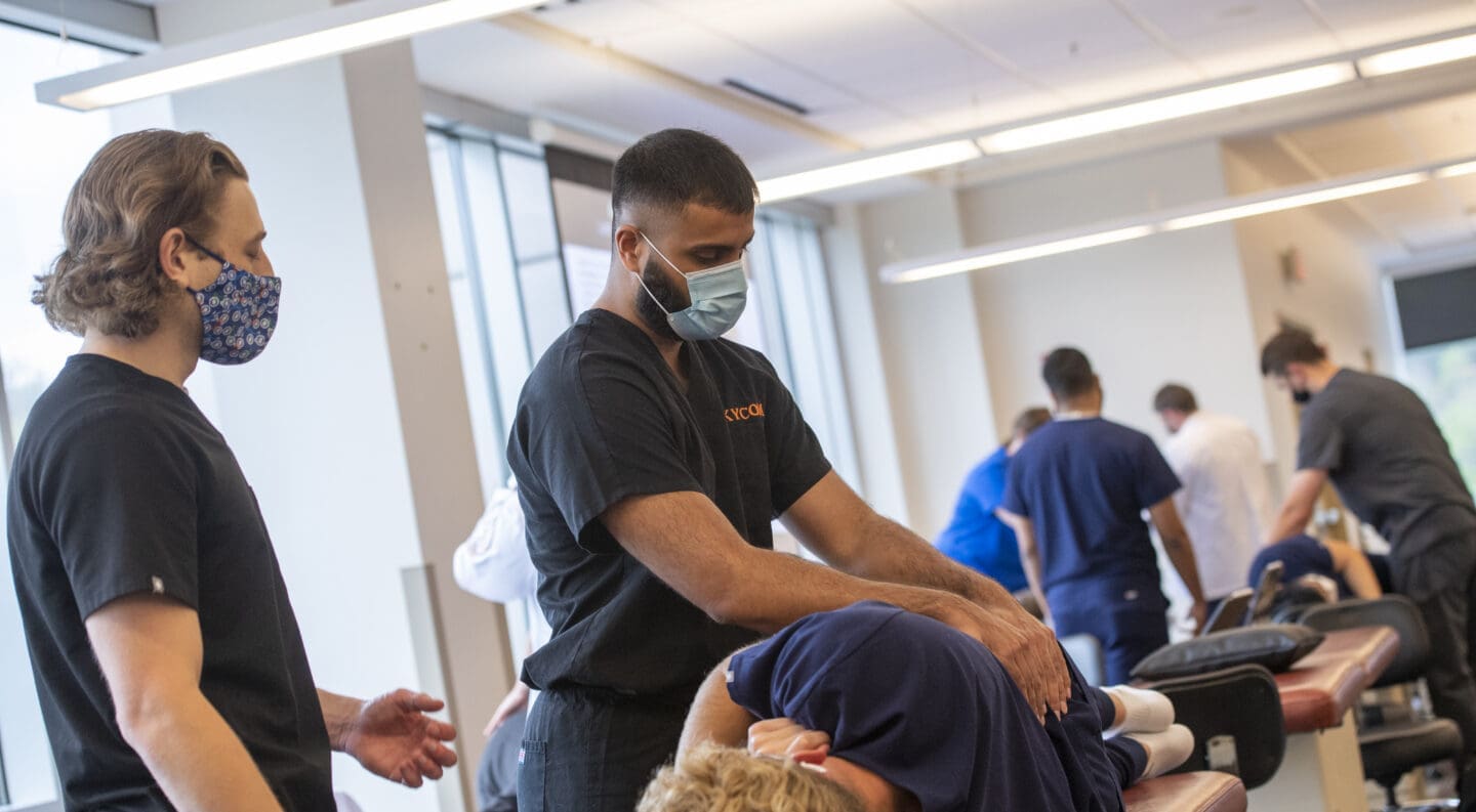 med student practicing omt techniques
