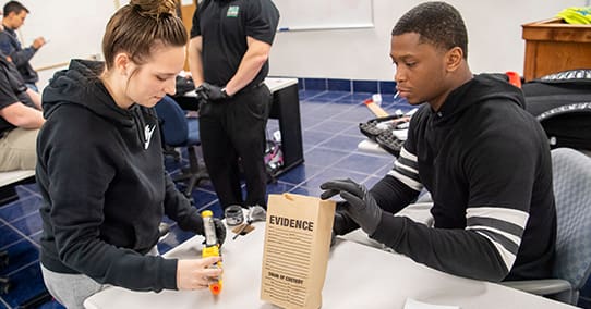Students collect evidence during forensics class.