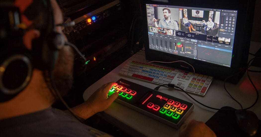 Student operating a switchboard during a broadcast.