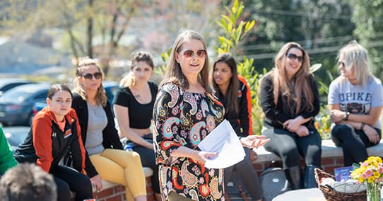 Kay Webb teaching a psychology class at the president's fire pit.