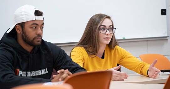 Student speaking during a group discussion.