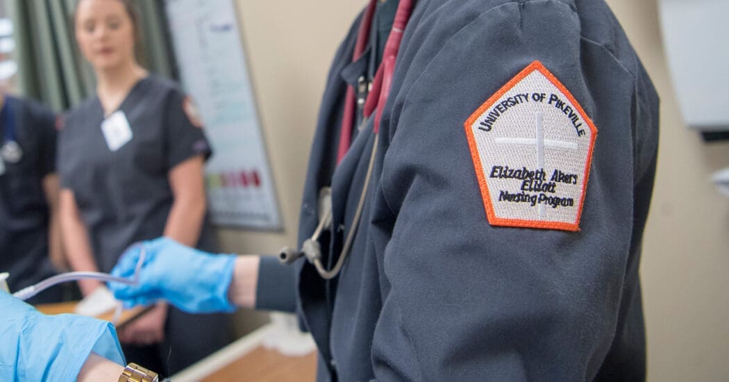 photo of UPIKE nursing student wearing her scrubs with elliott school of nursing patch