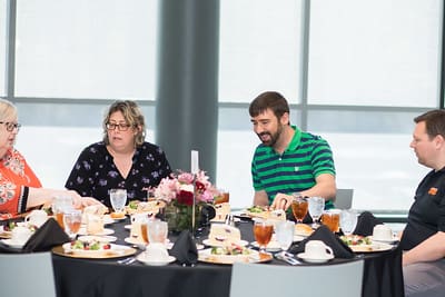 UPIKE employees gathered around a table
