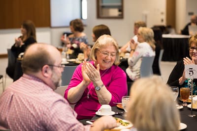 Luncheon guests applaud speaker