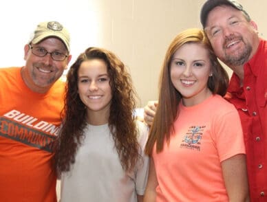 two students with their fathers during move in day