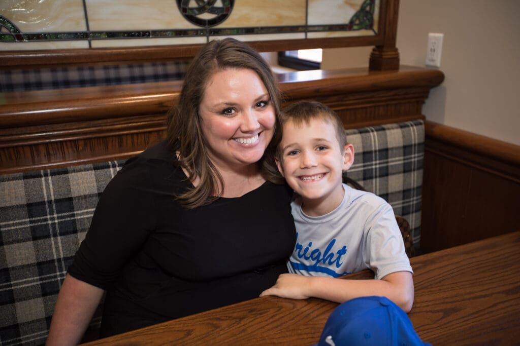 a guest with her son at a table
