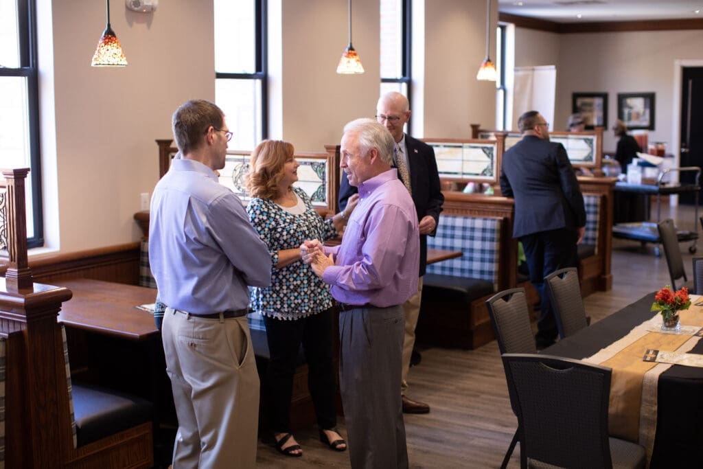 group of guests speaking to one another
