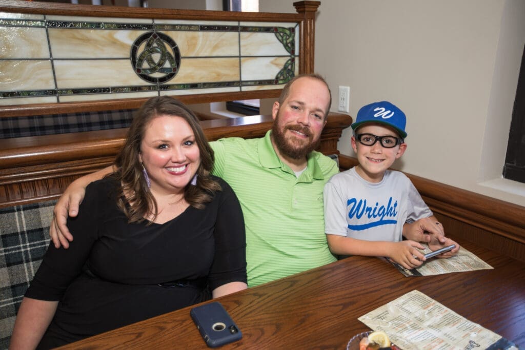 family seated at a booth at the event