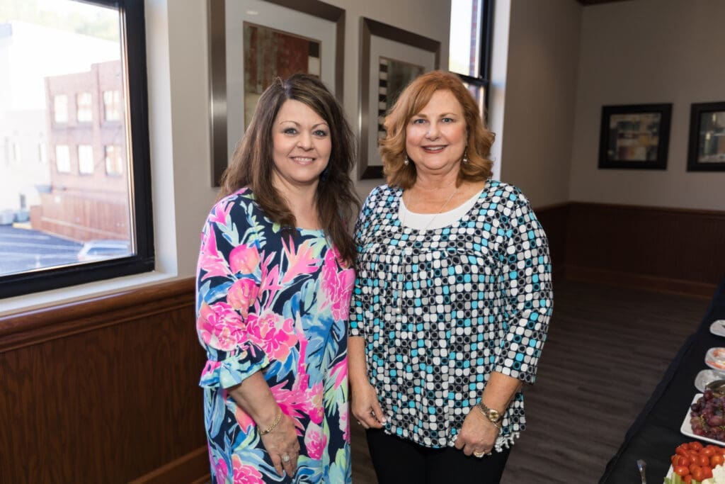 two guests pose for a photo together