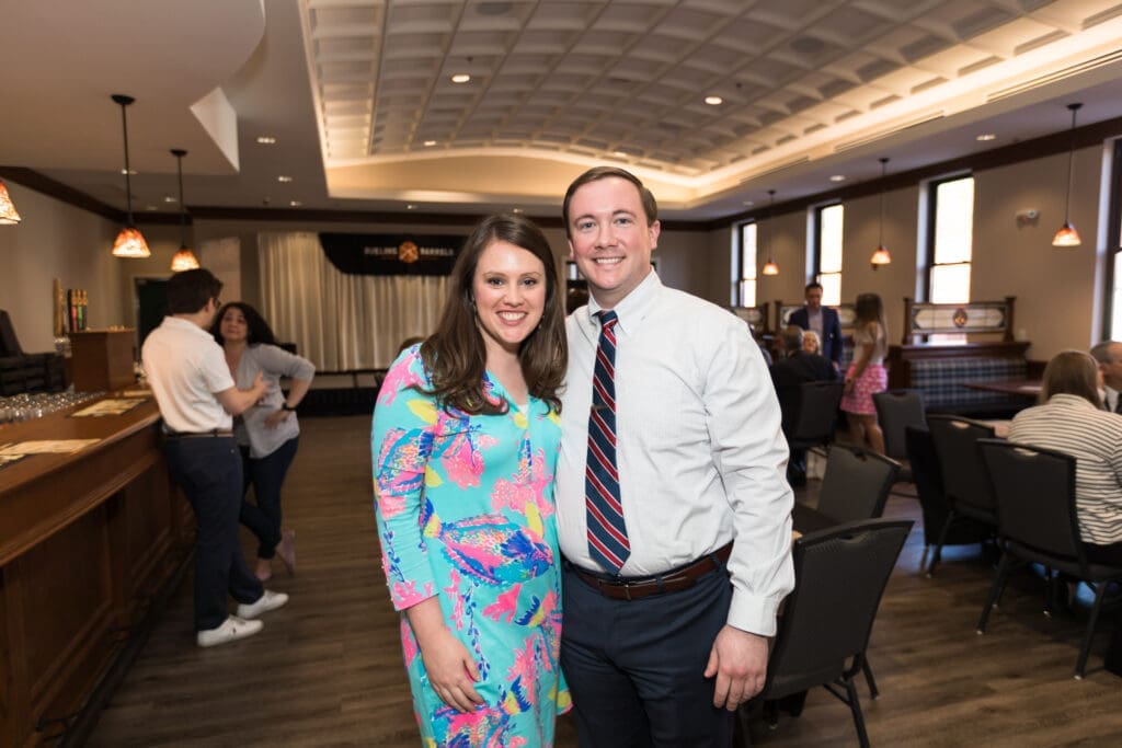 a couple pose for a photo during the event