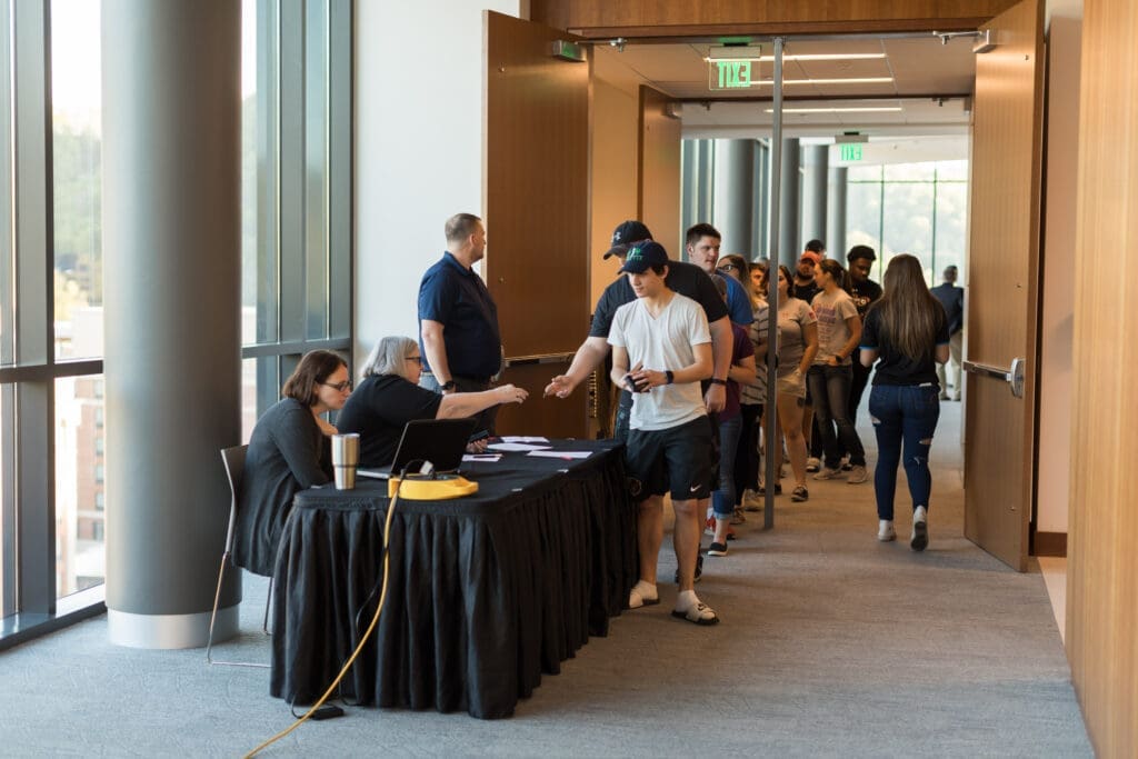 students checking in for the Judicial Speakers Series event