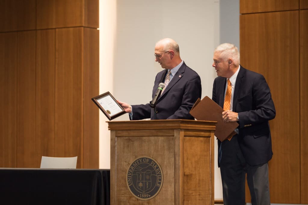 Rick Bartley accepting an award from Bill Baird