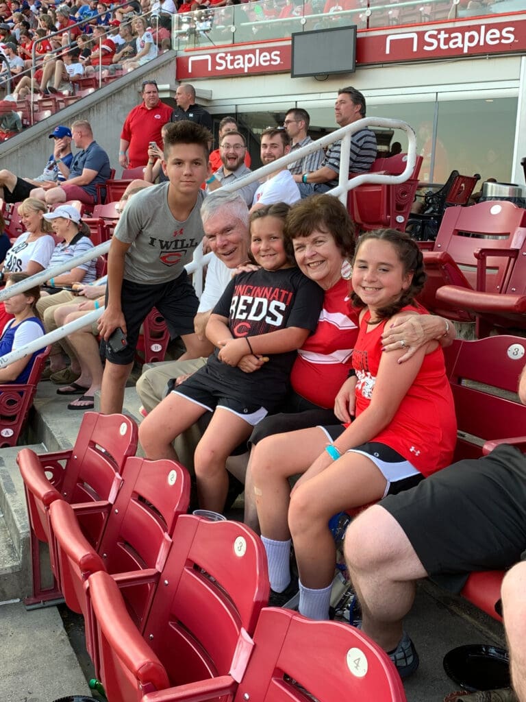 Family smiling at the baseball field