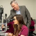 KYCO dean working with student on the new VR Biomicroscope simulator