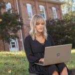 Student outside on a laptop