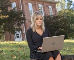 Student outside on a laptop