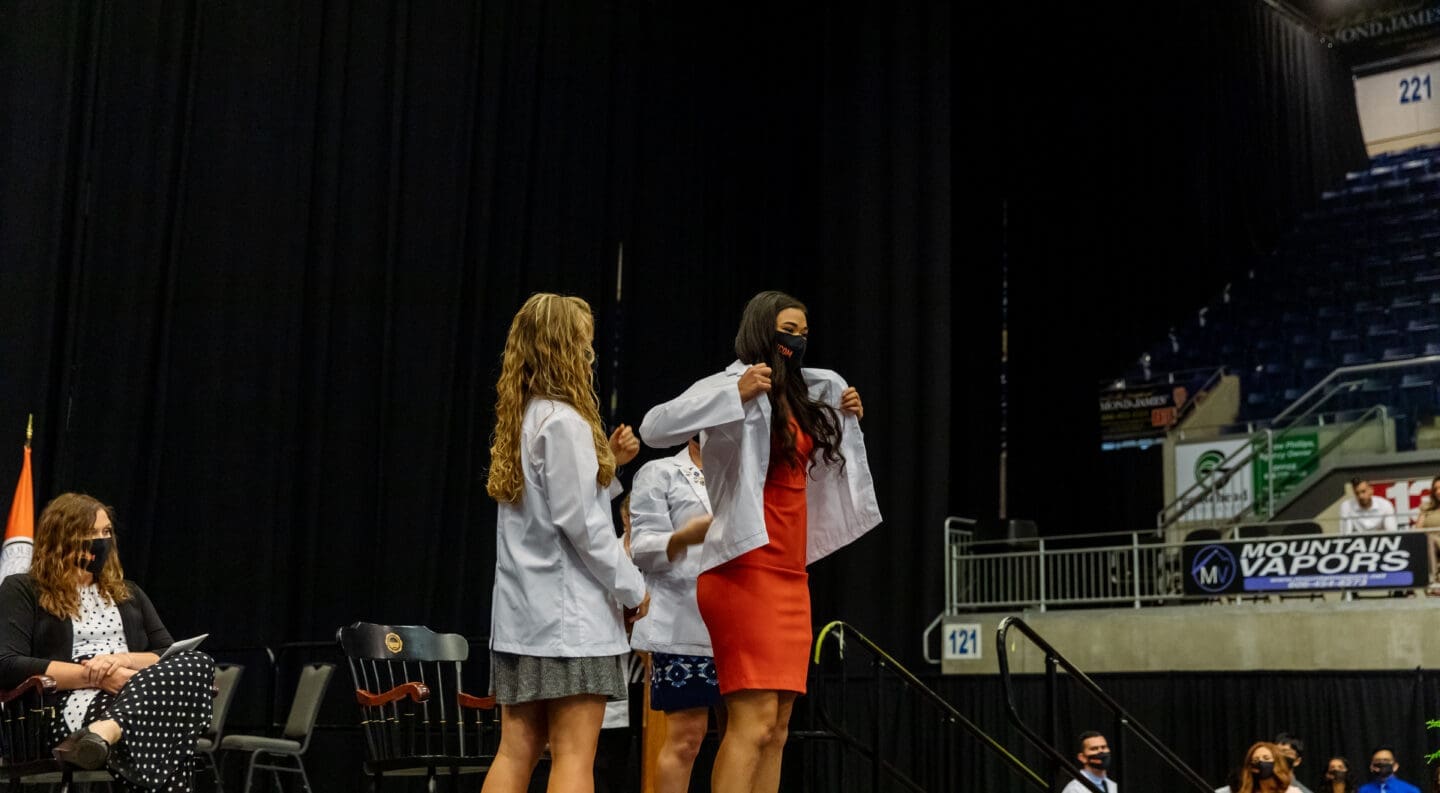 med student receiving white coat