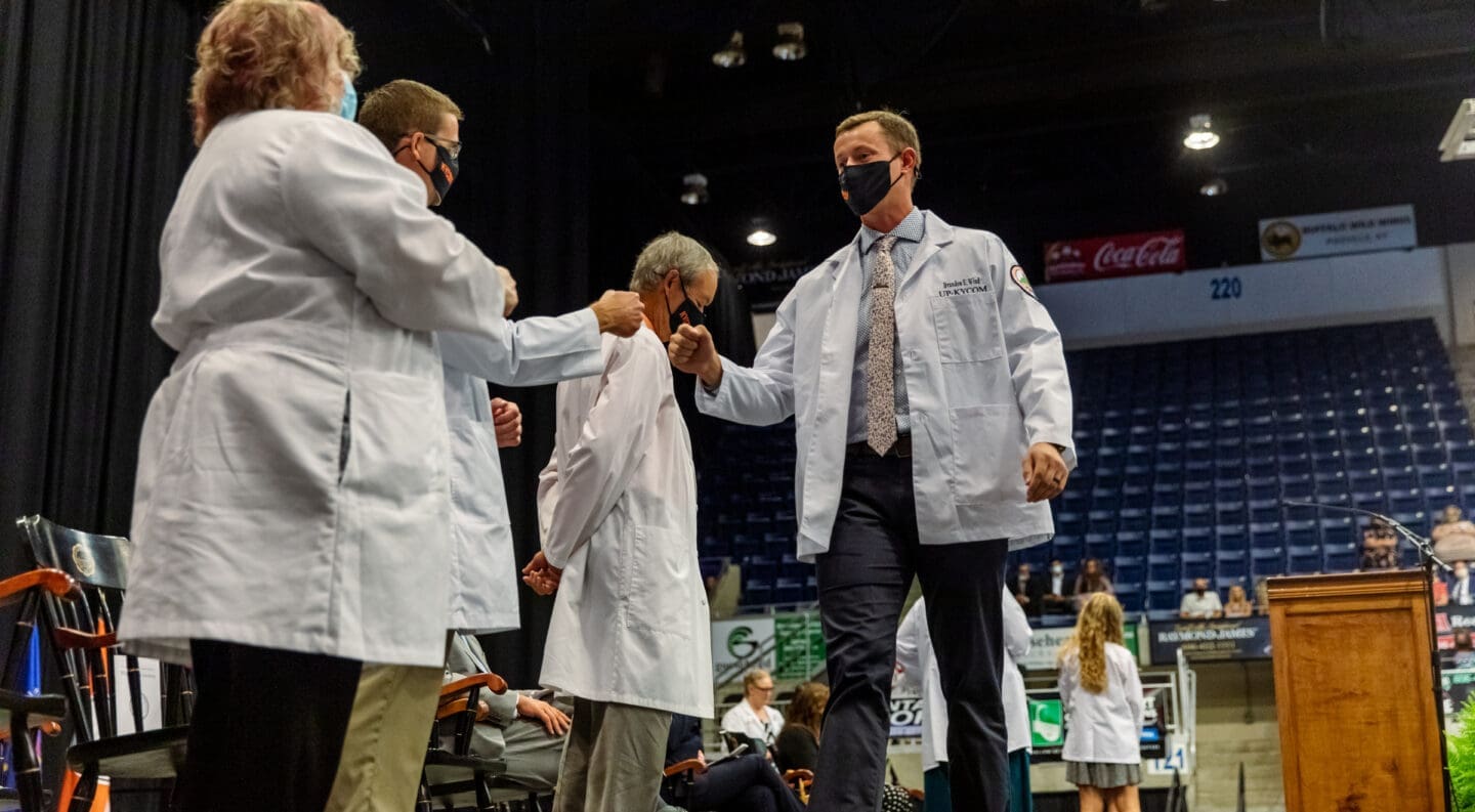 med student fist bumping dean
