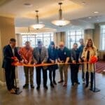City and university leaders cut a ribbon at Table 99 on UPIKE's campus