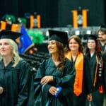 Undergraduate students walking in to take their seats at the ceremony.