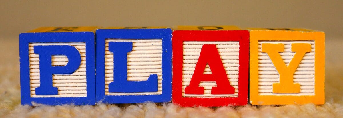 Toy blocks that spell out PLAY